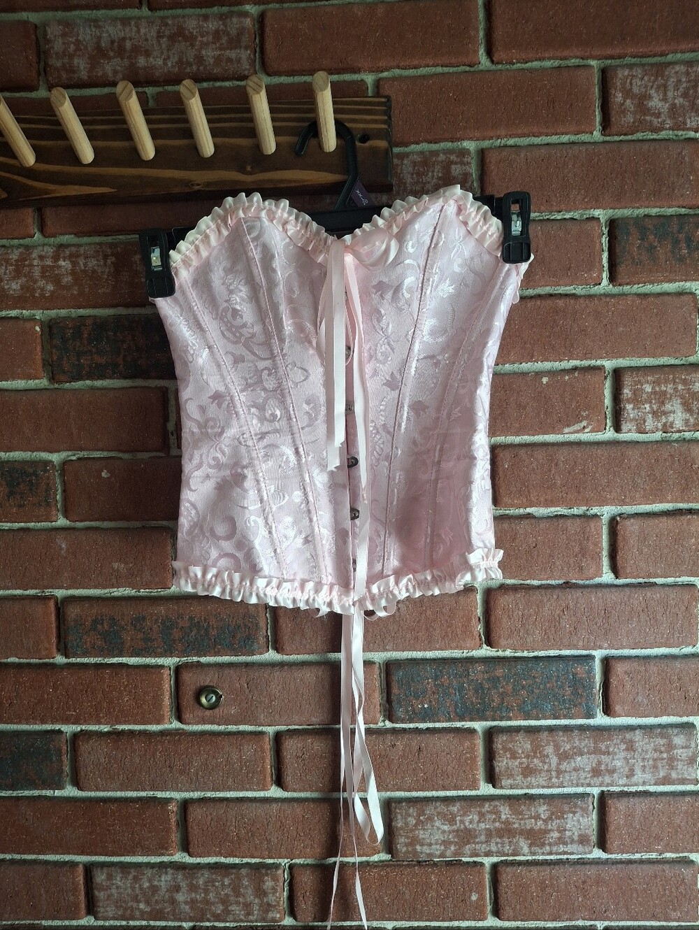 Pink corset top with lace and ribbon details